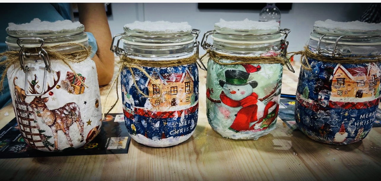 Create cherished memories while decoupaging festive cookie jars in a cozy setting surrounded by inspiring designs and a shared love for creativity that travelers can enjoy.