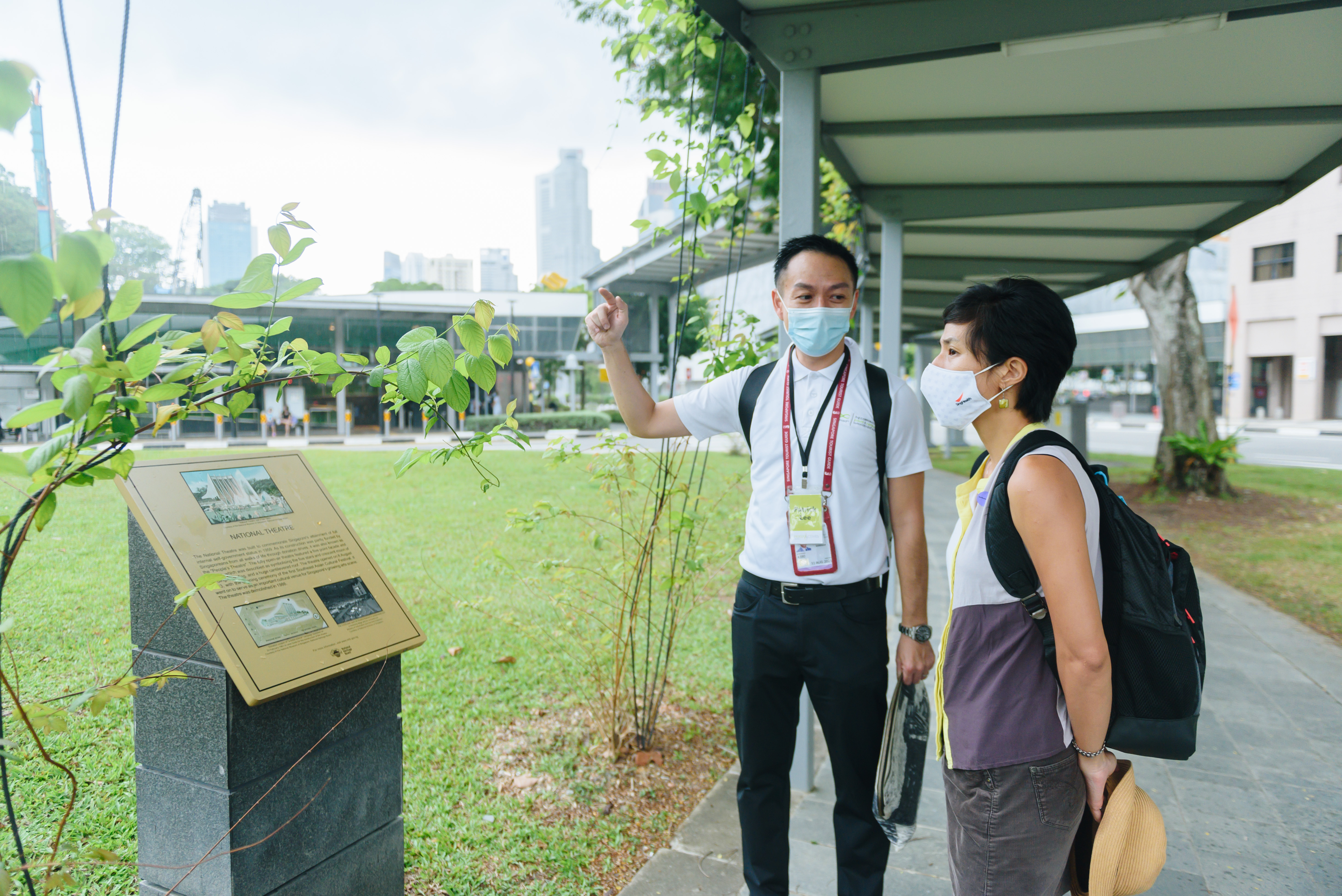 Explore the intriguing legacy of rubber and opium in Singapore as guides share insights into their profound impact on history and culture against a backdrop of lush greenery and urban landscapes.