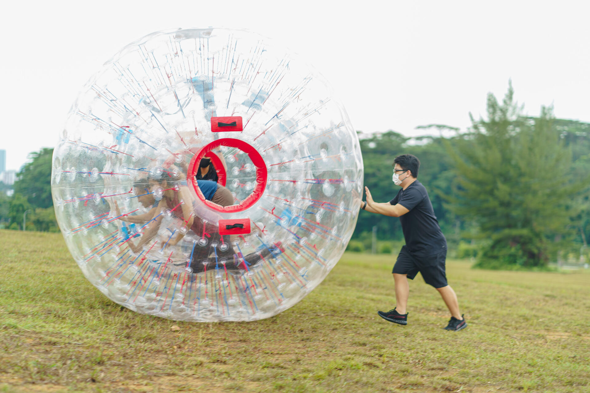Experience a unique blend of excitement with laser clay shooting and ZOVB-ing in Singapore where rolling downhill in a giant ball meets hitting targets in a fun outdoor setting.