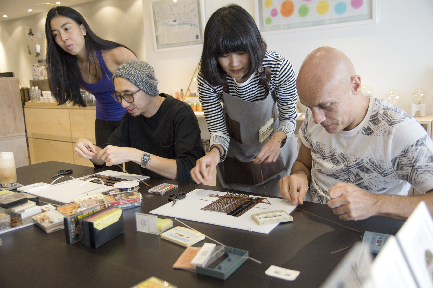 Experience the joy of creativity as participants skillfully transform old cassette tapes into unique art pieces embracing sustainability while crafting personalized memories in a lively workshop setting.
