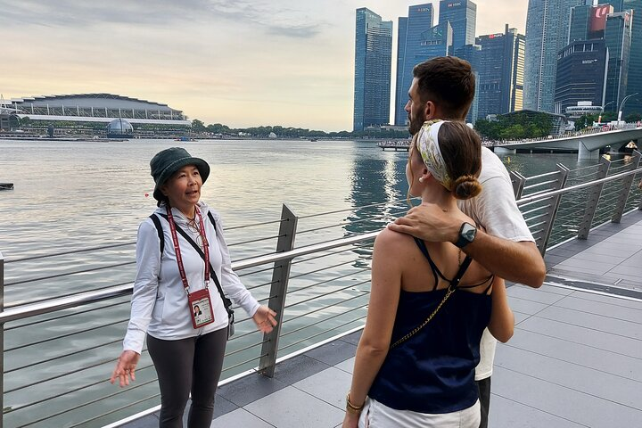 Experience the transformation of Singapore's Marina Bay as a guide shares stories about its evolution from open sea to a vibrant urban landscape enriching your journey through this iconic area.