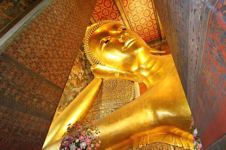 Immerse in Bangkok's rich culture by exploring majestic temples and stunning sights. Experience the serenity of the Reclining Buddha and capture unforgettable moments in traditional attire.