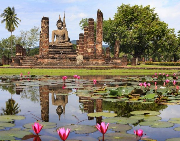 Ancient ruins framed by serene lotus ponds invite exploration revealing the rich history and splendor of Thailand's past amidst the natural beauty of Sukhothai. Experience the essence of time.