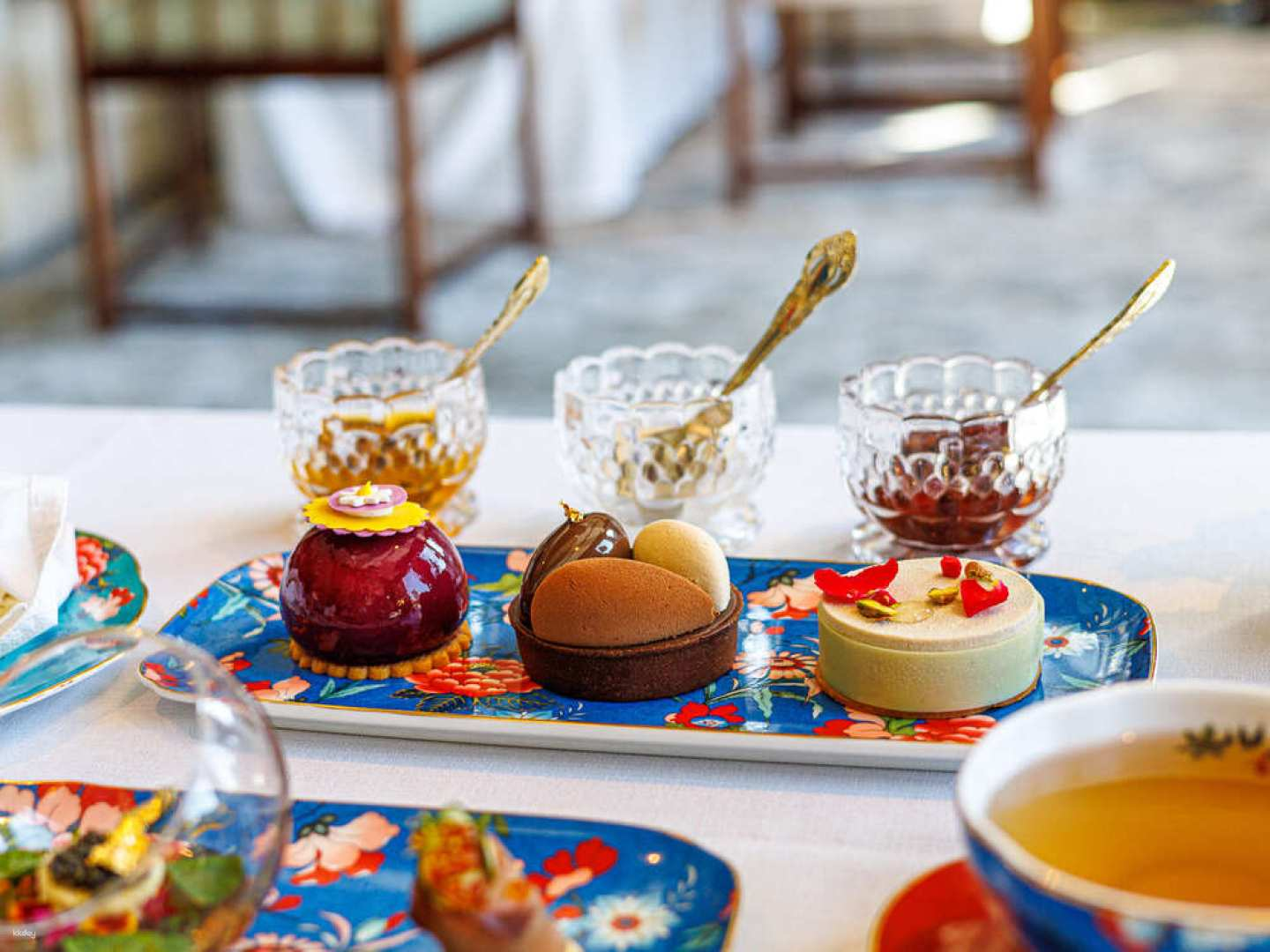 Indulge in a delightful afternoon tea experience at Capella Bangkok featuring exquisite desserts while overlooking the serene Chao Phraya River perfect for a leisurely escape in the city.