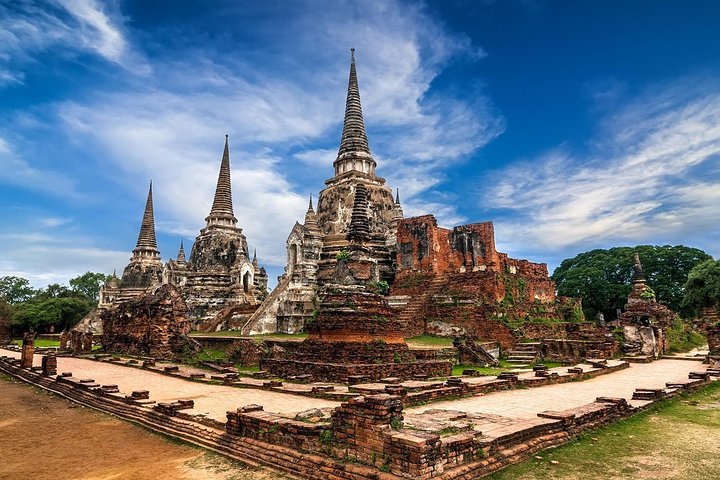Explore the ancient ruins of Ayutthaya where majestic pagodas and historical treasures reveal the rich legacy of Thailand's past during a memorable river cruise experience.
