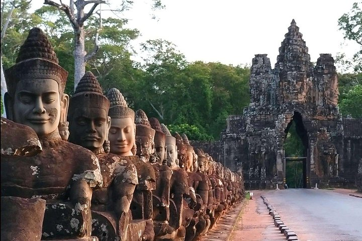 Discover the timeless beauty of Angkor Thom where towering stone faces greet travelers guiding them toward the majestic gates of ancient history and remarkable temples hidden among lush surroundings.