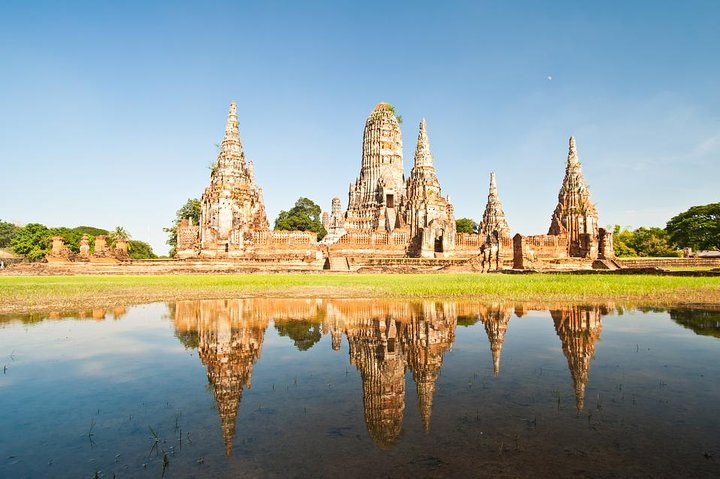 Discover the historical charm of Ayutthaya with stunning reflections in the water as ancient temple structures tell stories of a glorious past inviting travelers to explore its rich heritage.