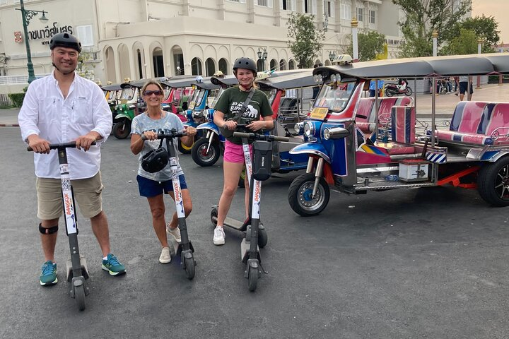 Explore Bangkok's historic charm on electric scooters blending sightseeing and adventure as you glide past iconic landmarks with ease and delight in the city's rich culture.