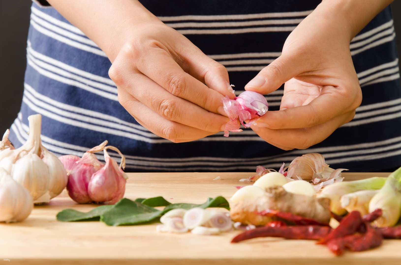 Experience the art of Thai cooking with fresh ingredients as hands skillfully prepare traditional flavors that transport you straight to the heart of Bangkok's culinary scene.
