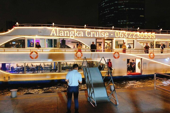 Sail through Bangkok's illuminated skyline on a serene dinner cruise savoring a delicious international buffet and enjoying live music all while exploring iconic riverside landmarks.