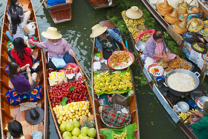 Experience the charm of Thailand's floating markets where colorful boats brim with fresh fruits and local delicacies creating a unique slice of cultural life. Enjoy a paddleboat ride through this lively scene.