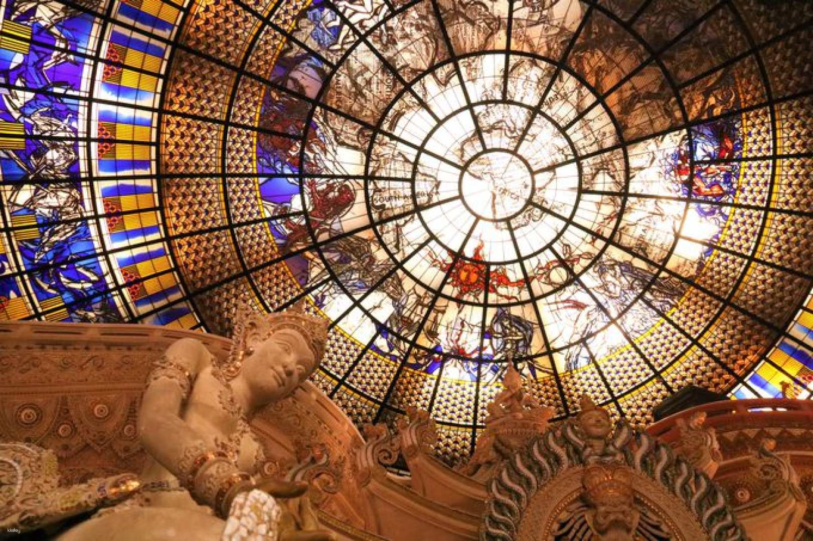Witness the intricate artistry of Erawan Museum as sunlight dances through its stunning stained glass dome creating a magical backdrop for unforgettable photos and discovery in Bangkok's cultural gems.
