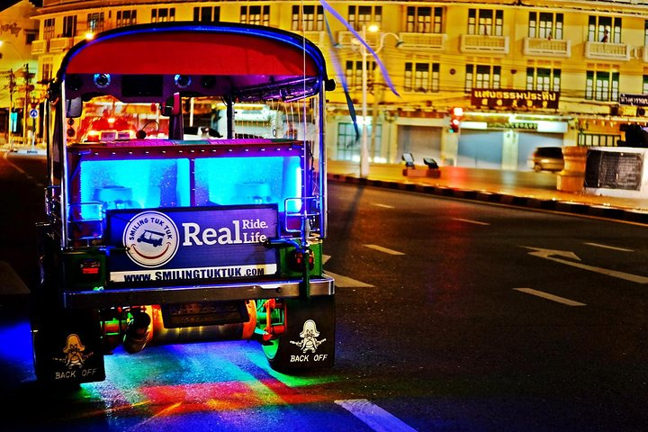 Experience the charm of Bangkok as your Tuk Tuk glides through illuminated streets showcasing stunning temples and vibrant local life culminating in a breathtaking rooftop view with your favorite drink.