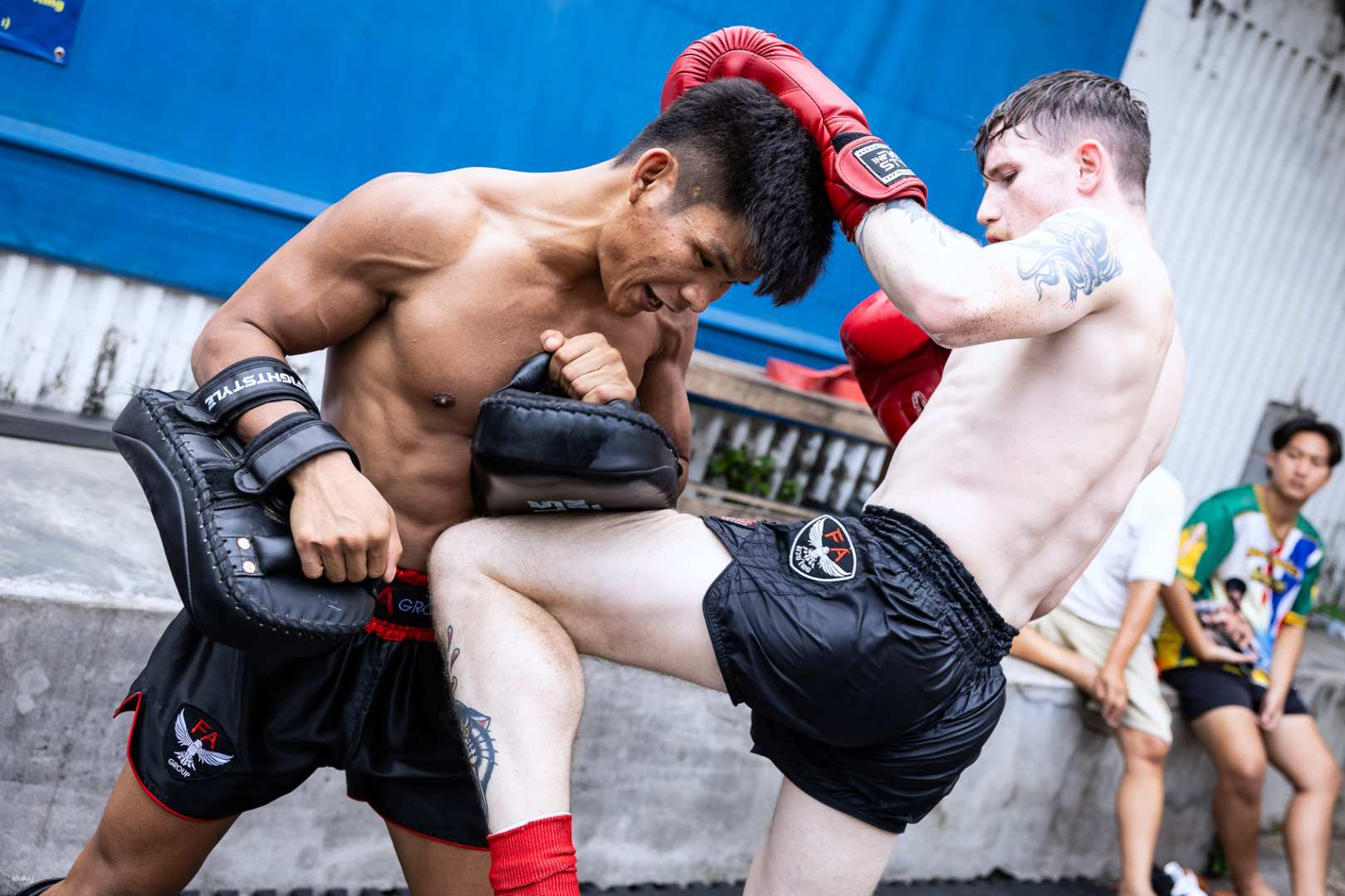 Immerse yourself in the energy of a Muay Thai class in Bangkok where beginners learn vital techniques under the guidance of experienced fighters all while enhancing self-defense skills.