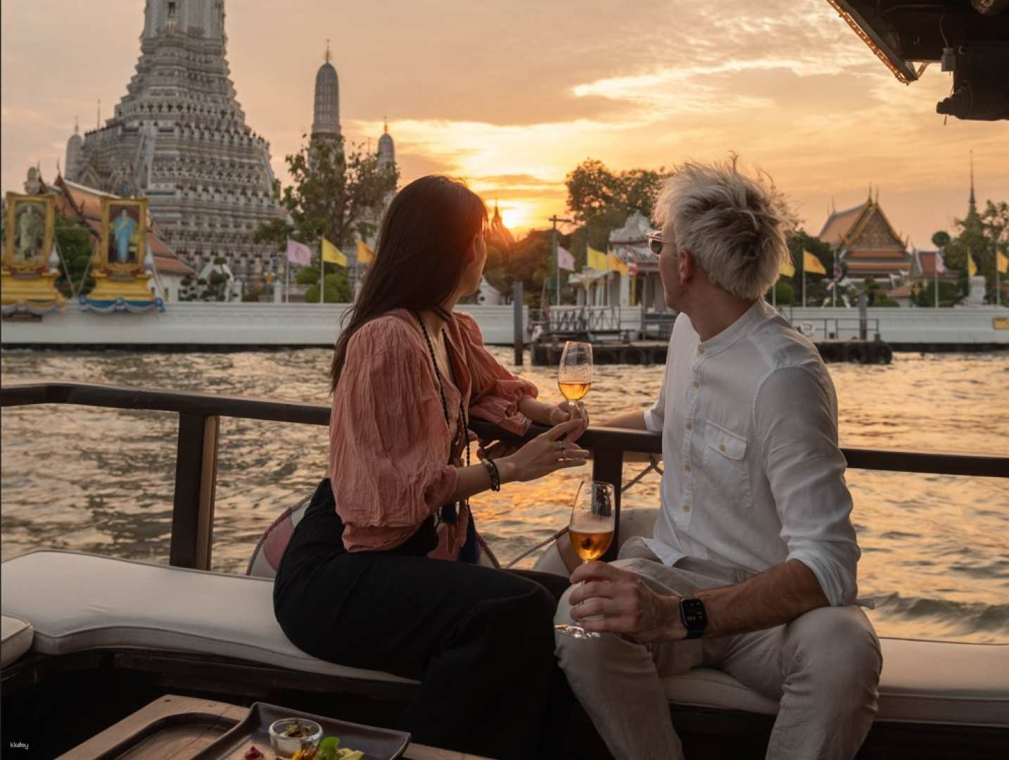 Savor the splendor of Bangkok's skyline at sunset while enjoying exquisite cocktails and delightful canapés surrounded by historic landmarks along the Chao Phraya River.