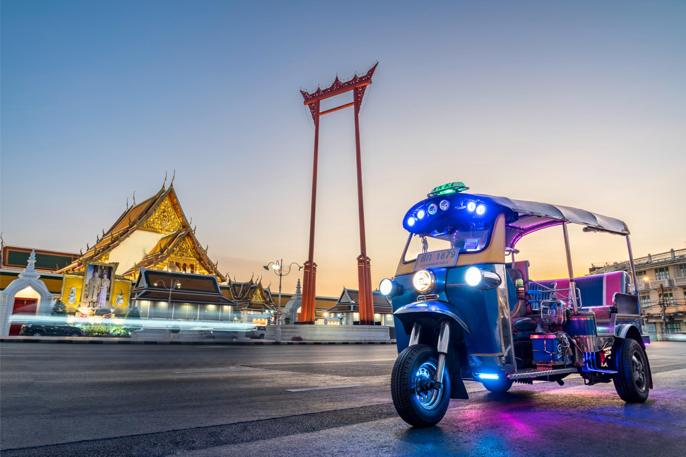 Experience the charm of Bangkok as you ride a tuk-tuk through its historic streets discovering local delicacies and hidden gems all under a stunning twilight sky.