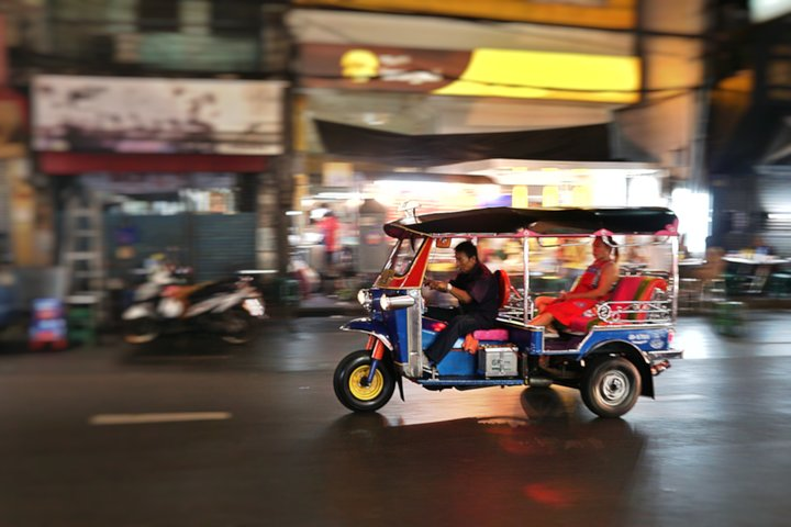 Experience the rush of Bangkok’s streets aboard a tuk-tuk weaving through bustling markets and vibrant city life making every moment a snapshot of adventure and discovery.
