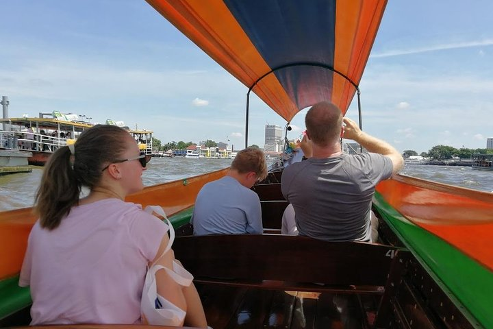 Experience Bangkok from the water aboard a traditional longtail boat soaking in views of historic temples and bustling markets while enjoying the charm of local life unfolding around you.