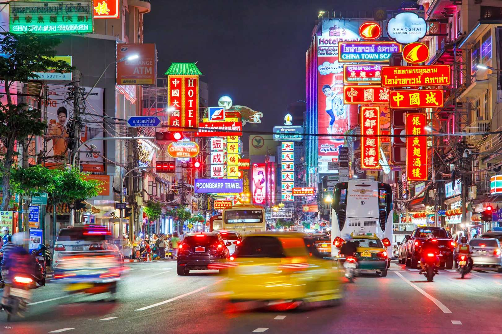 Experience the lively streets of Bangkok at night while tasting delicious street food in Chinatown. Iconic landmarks illuminated under the night sky create an unforgettable journey.