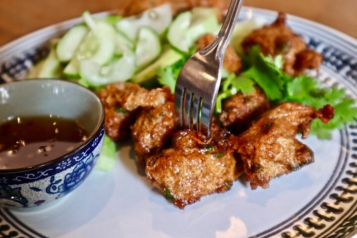 Savor the authentic flavors of Bangkok with crispy delights fresh cucumber and a tangy dipping sauce showcasing local culinary secrets and the charm of hidden street food treasures.