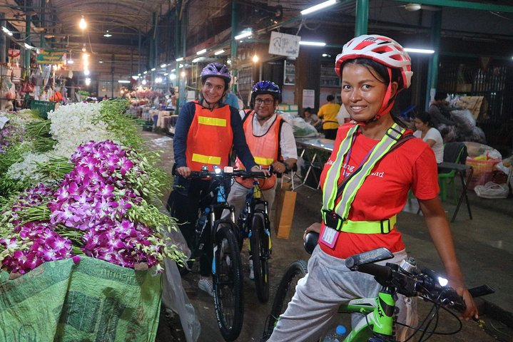 Experience the charm of Bangkok's flower market while cycling through the bustling streets surrounded by fresh blooms and the excitement of local life after dinner.