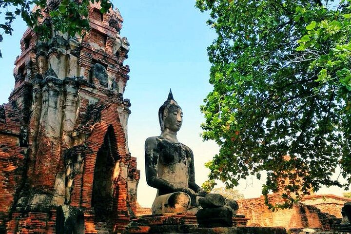 Bike through Ayuthaya's historic ruins by day then savor a delightful dinner cruise under the night sky surrounded by ancient temples illuminating the river's serenity.