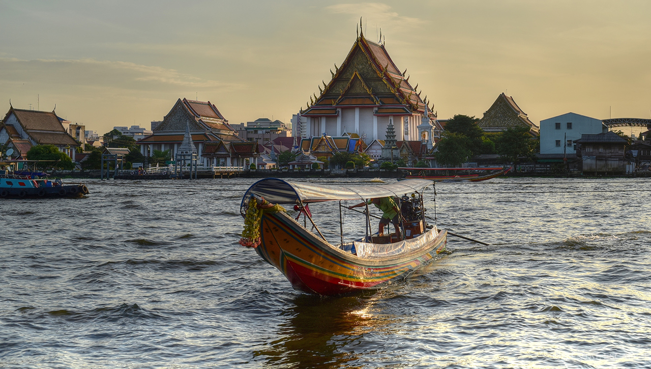 Explore Bangkok's historical landscape as you glide along the Chao Phraya River witnessing stunning temples and riverside charm perfect for those seeking a unique evening adventure.