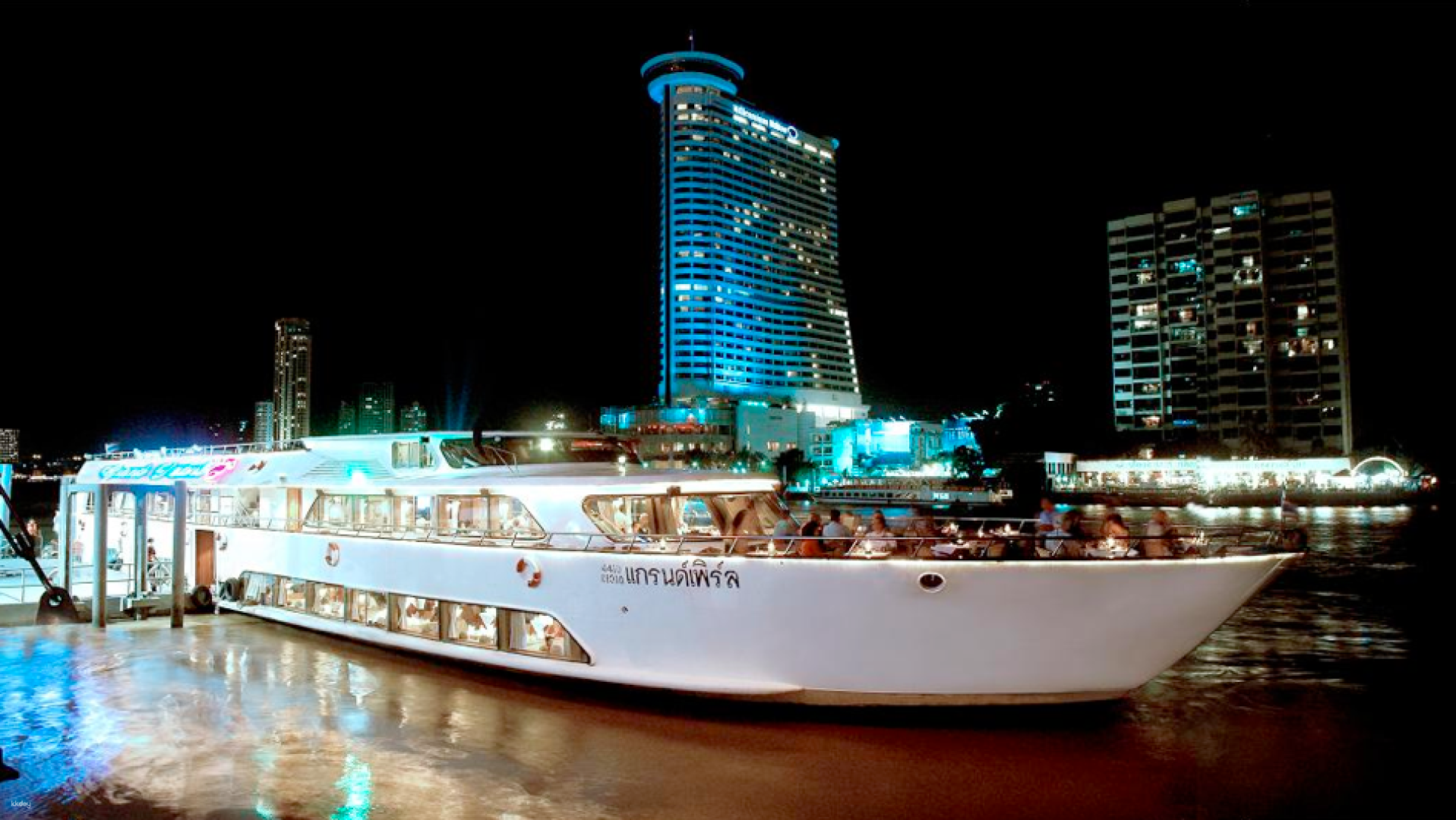 Experience a luxurious evening on the Chao Phraya River savoring exquisite cuisine and breathtaking views of Bangkok's iconic landmarks from a beautifully designed cruise vessel.
