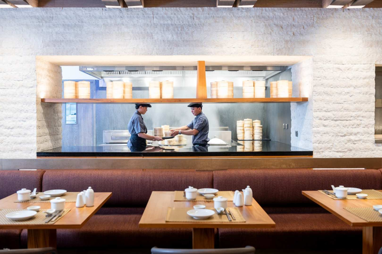Experience the art of Chinese cuisine at Man Ho Bistro where chefs skillfully prepare dishes in an inviting setting perfect for sharing memorable meals with loved ones in Bangkok.