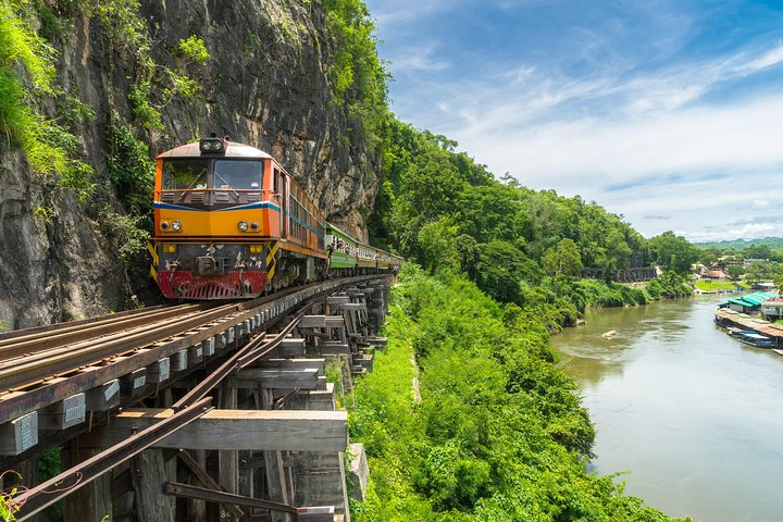 Experience the scenic journey along the historic Death Railway where lush landscapes and the tranquil River Kwai create an unforgettable backdrop for your Kanchanaburi adventure.