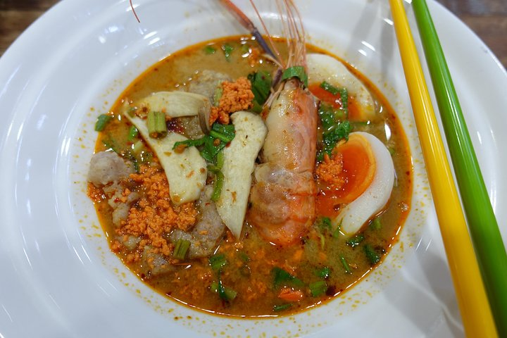 Experience the diverse flavors of Thai cuisine from spicy soups to fresh ingredients while exploring a local market and learning how to navigate menu choices like a true local.