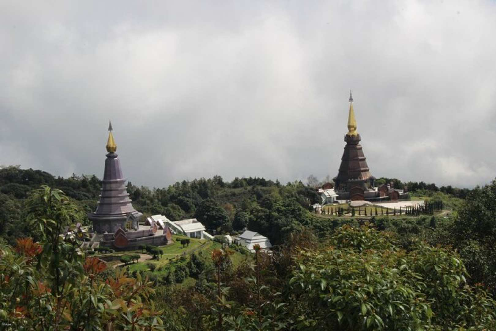 Experience the beauty of Doi Inthanon National Park with its stunning pagodas set against lush greenery perfect for exploring trails and immersing in local culture.
