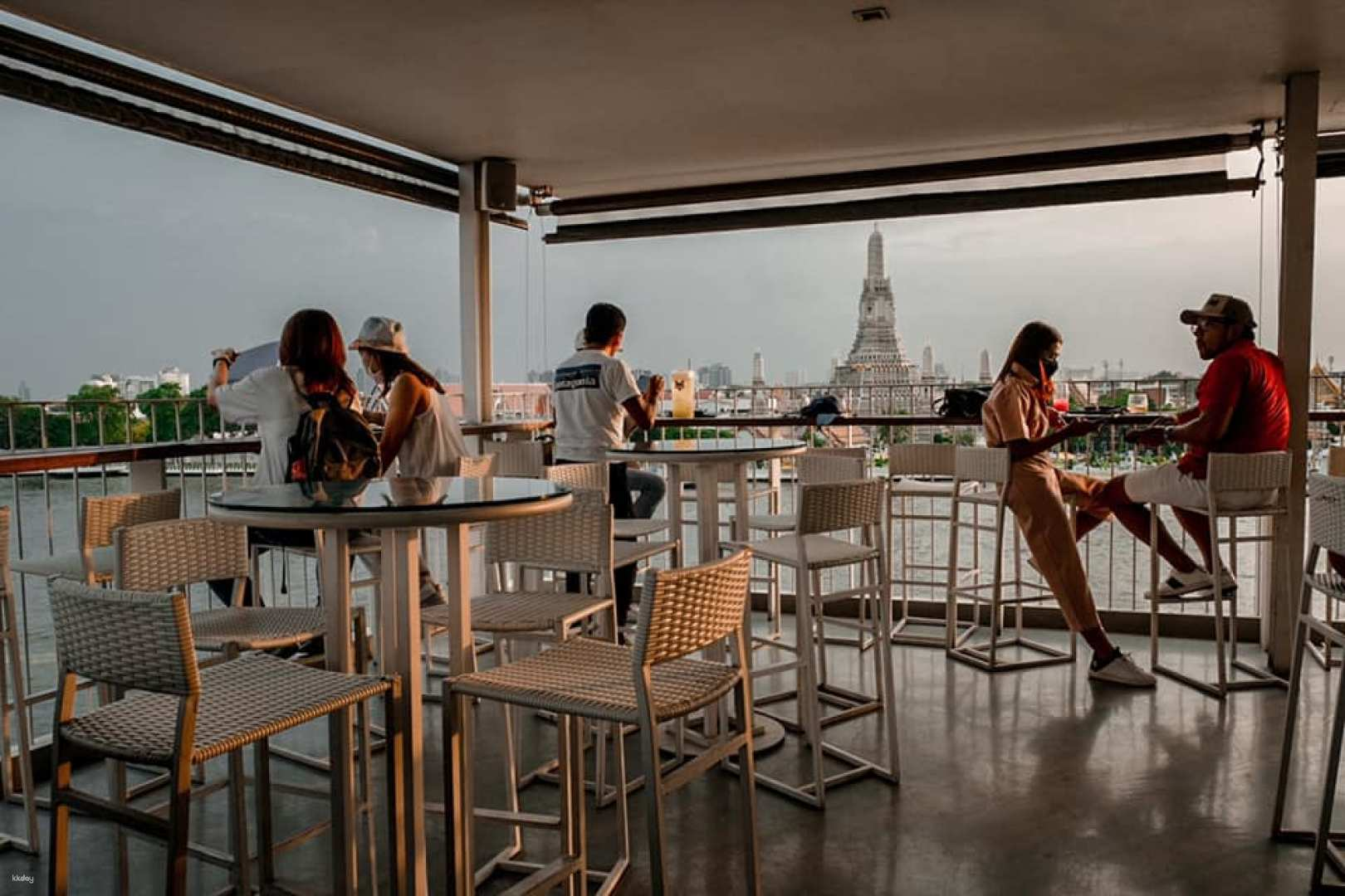 Sip on expertly crafted cocktails while enjoying stunning views of Bangkok's skyline and the Chao Phraya River creating unforgettable moments as the sun sets behind iconic landmarks.