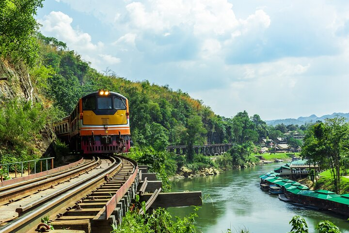 Experience the stunning landscapes of Kanchanaburi as the train journeys alongside the river revealing picturesque views and whispers of history that beckon every traveler to explore deeper.