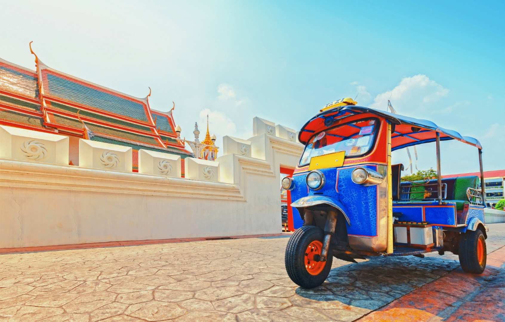 Explore Bangkok's Old Town in a traditional Tuk-Tuk taking in landmarks like the Giant Swing and Wat Arun while experiencing the local culture and vibrant street life.