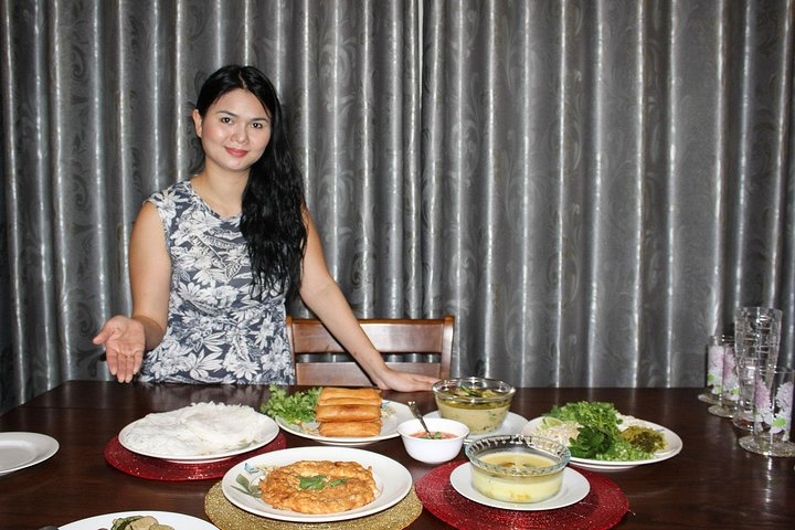 Savor the taste of authentic Thai cuisine in a warm Bangkok home featuring a spread of traditional dishes lovingly prepared by Phim an experienced home cook eager to share her culinary passion.