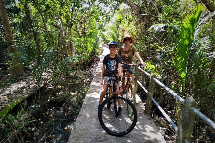 Pedal through lush greenery and serene pathways enjoying a unique family adventure on bamboo bikes where nature's beauty meets safe exploration perfect for travelers of all ages.