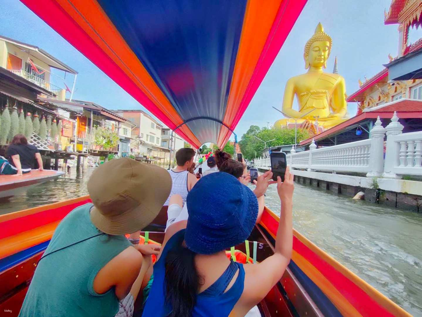 Experience the charm of Bangkok's Yai Canal as you glide past traditional homes and capture the impressive Buddha statue at Wat Paknam for an unforgettable cultural journey.