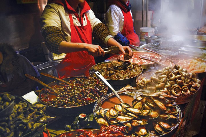 Savor the lively street food scene where sizzling dishes and bursting flavors await. Experience authentic Thai cuisine freshly prepared before your eyes in bustling night markets.