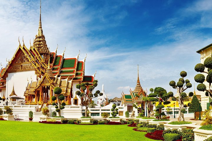 Discover Bangkok's rich heritage as you wander through the stunning grounds of the Grand Palace marveling at intricate architecture and lush gardens that tell tales of history and culture.