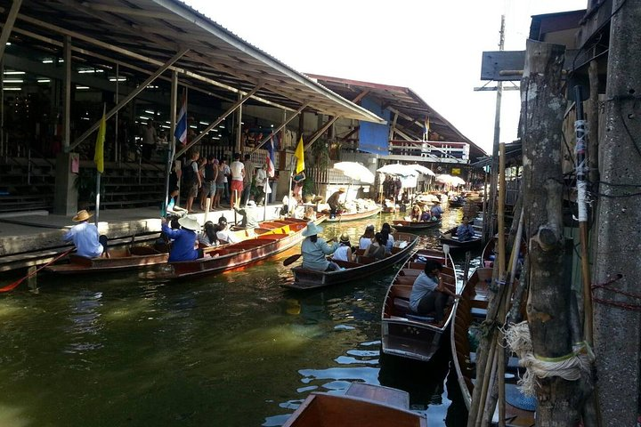 Discover the charm of bustling boats filled with colorful goods as the Damnern Saduak Floating Markets offer a unique glimpse into local life and trade against a picturesque backdrop.