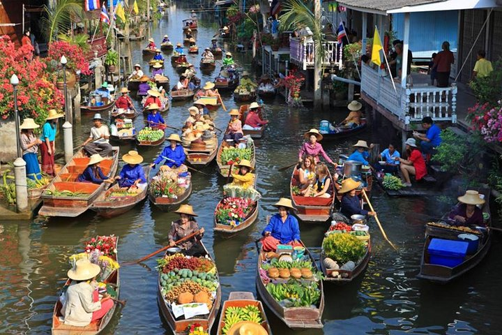 Explore a lively scene where colorful boats fill the waterways as vendors skillfully navigate selling fresh produce showcasing a unique blend of tradition and daily life in Bangkok's signature markets.