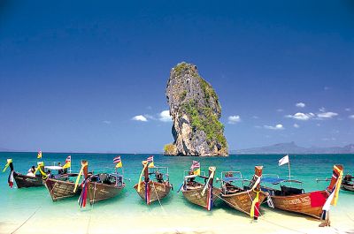 Explore the stunning beauty of Krabi's islands aboard a long-tail boat where secluded beaches invite you to swim snorkel and relax under the sun. Discover diverse marine life and natural wonders.