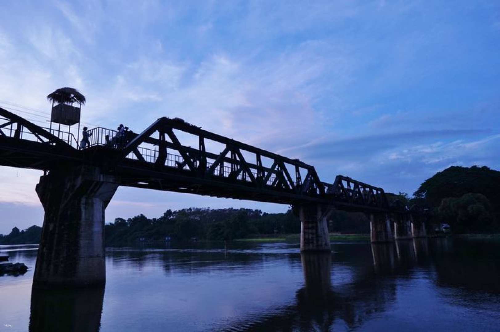 Experience the charm of a Thai-style railway journey to Kanchanaburi exploring scenic views and the iconic Bridge on the River Kwai while enjoying complimentary snacks and drinks.