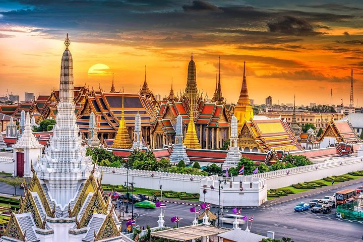 Experience Bangkok's rich heritage where golden temples rise against a stunning sunset creating a perfect backdrop for exploration and learning about Thailand's spiritual traditions. A journey through time awaits.