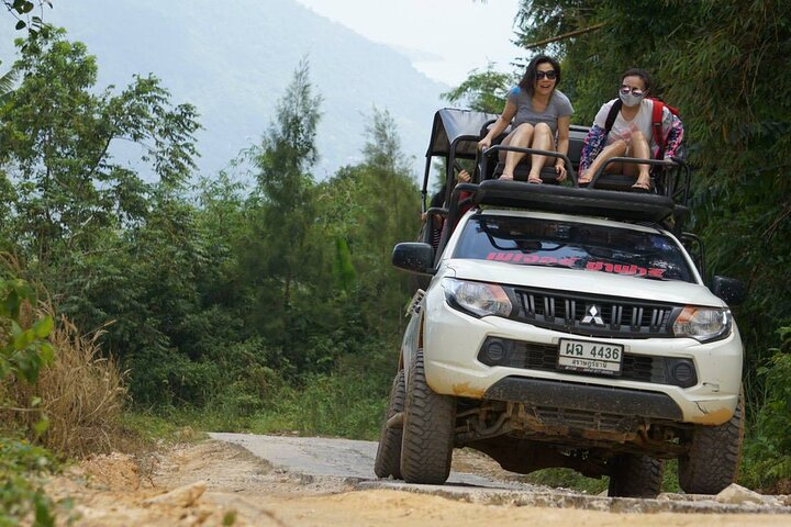 Experience the excitement of exploring Koh Samui's scenic trails in a modified jeep perfect for soaking in the island’s beauty and adventure with friends.