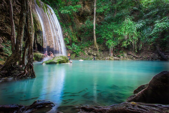 Experience the serene beauty of Erawan Falls where crystal-clear waters meet lush greenery inviting you for a refreshing dip and a connection with nature in Kanchanaburi.