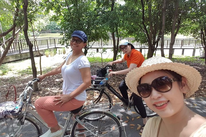 Experience the serenity of Bangkok's countryside as you bike through lush greenery connecting with nature and enjoying delightful moments with fellow travelers along the way.