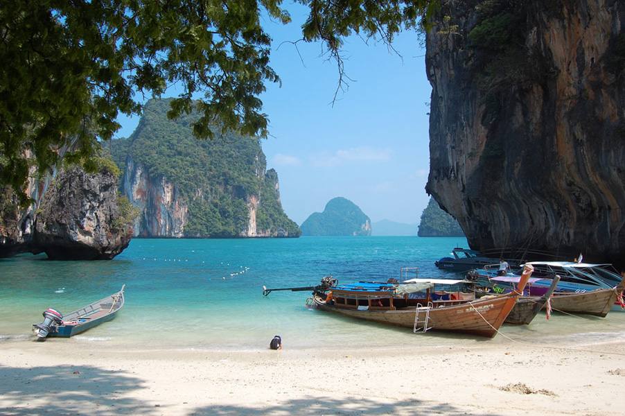 Explore pristine white sand beaches and clear tropical waters at the Hong Islands where towering limestone cliffs frame a perfect setting for swimming snorkeling and relaxation in nature.