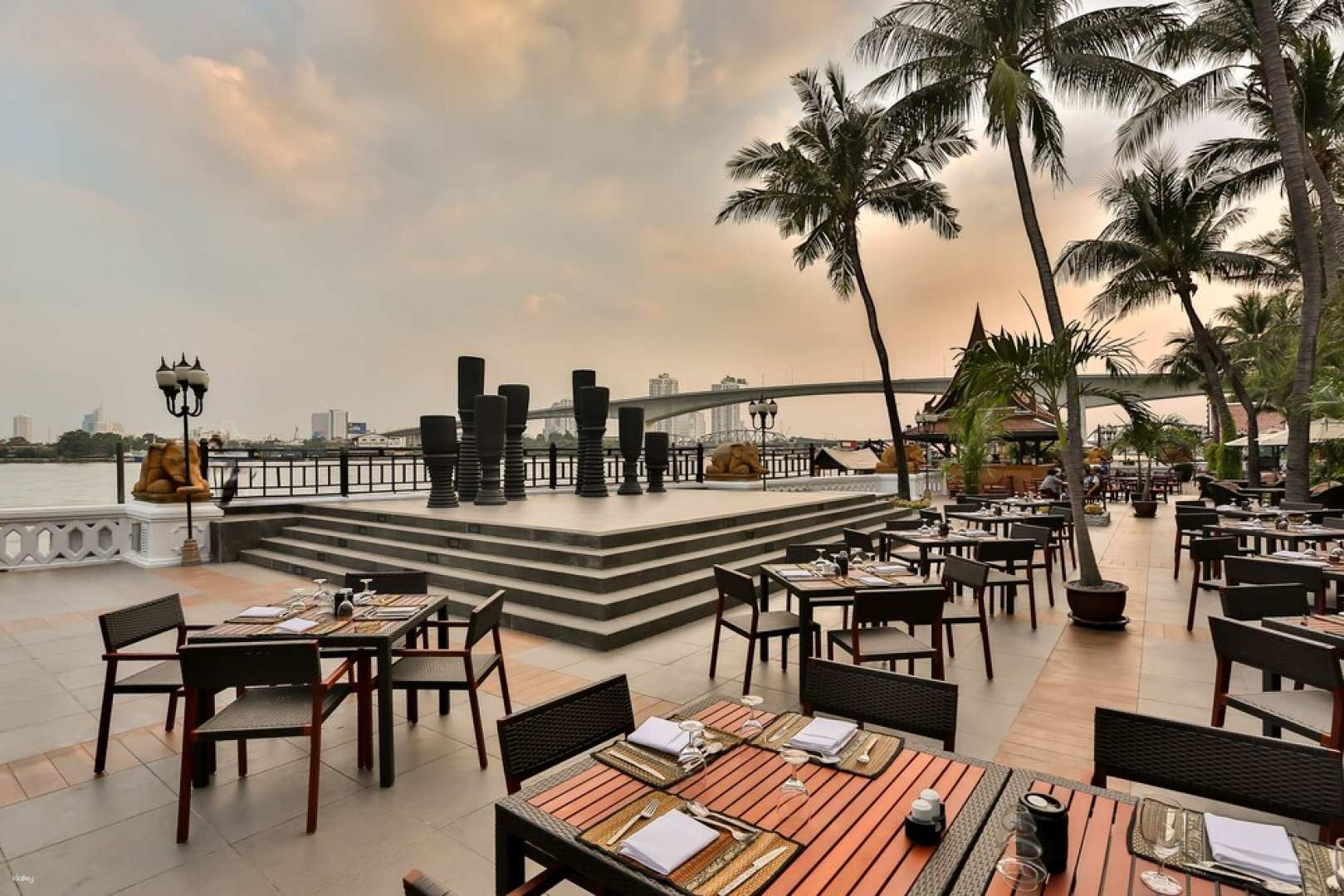 Savor a delightful BBQ buffet by the river surrounded by lush palms and stunning views while enjoying a live band performing exotic tunes to elevate your dining experience.